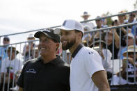 Phil Mickelson, left, and Stephen Curry pose for pictures before hitting from the first tee of the Silverado Resort North Course during the pro-am event of the Safeway Open PGA golf tournament Wednesday, Sept. 25, 2019, in Napa, Calif. (AP Photo/Eric Risberg)