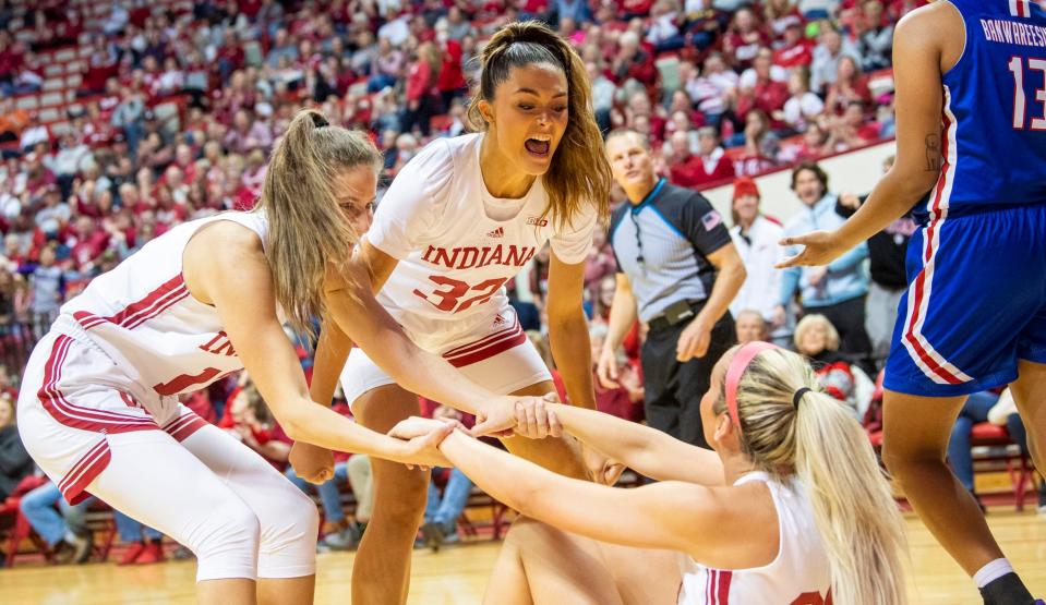 Indiana's Alyssa Geary (32) and Yarden Garzon (12) celebrate with Sydney Parrish (33) after her basket and foul during the first half of the Indiana versus UMass Lowell woment's basketball game at Simon Skjodt Assembly Hall on Friday, Nov. 11, 2022. 