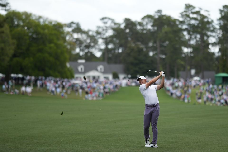 Rory McIlroy, of Northern Ireland, hits from the fairway on the first hole during the first round at the Masters golf tournament at Augusta National Golf Club Thursday, April 11, 2024, in Augusta, Ga. (AP Photo/Matt Slocum)