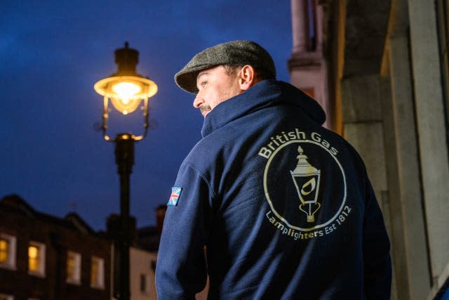 Lamplighter Paul Doy stands under one of four gas lamps along Russell Street in Covent Garden, London that have today been given Grade II listing protection.