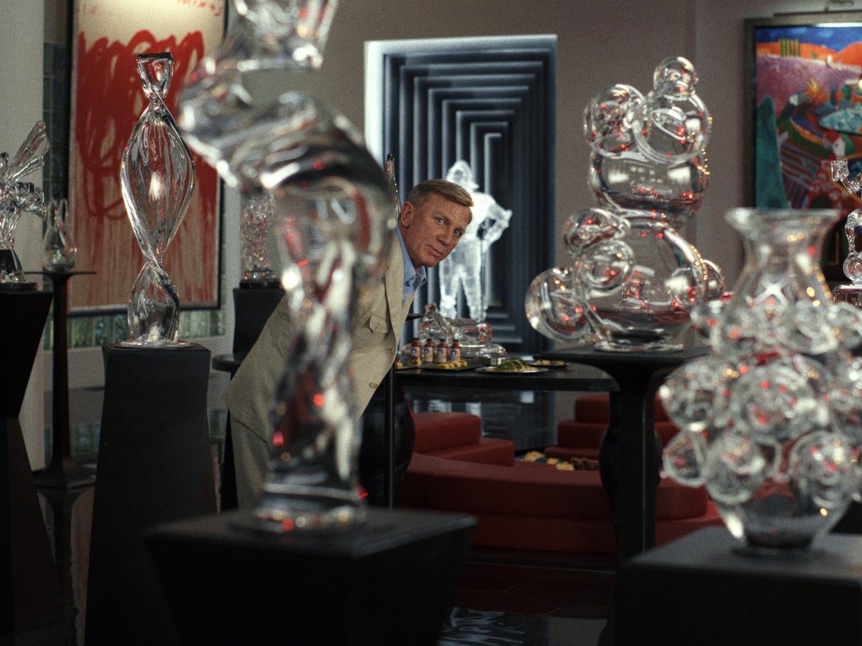 Daniel Craig surrounded by glass sculptures