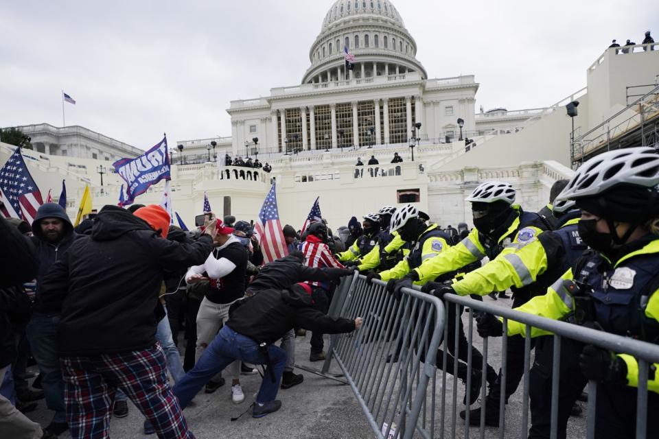 Rioters break through barrier.