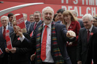 Jeremy Corbyn, Leader of Britain's opposition Labour Party laughs upon arriving for the launch of Labour's General Election manifesto, at Birmingham City University, England, Thursday, Nov. 21, 2019. Britain goes to the polls on Dec. 12. (AP Photo/Kirsty Wigglesworth)