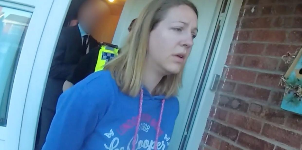 in this frame from a police body camera video provided by cheshire constabulary, lucy letby is arrested and is seen walking out of her home in handcuffs whilst wearing casual clothes