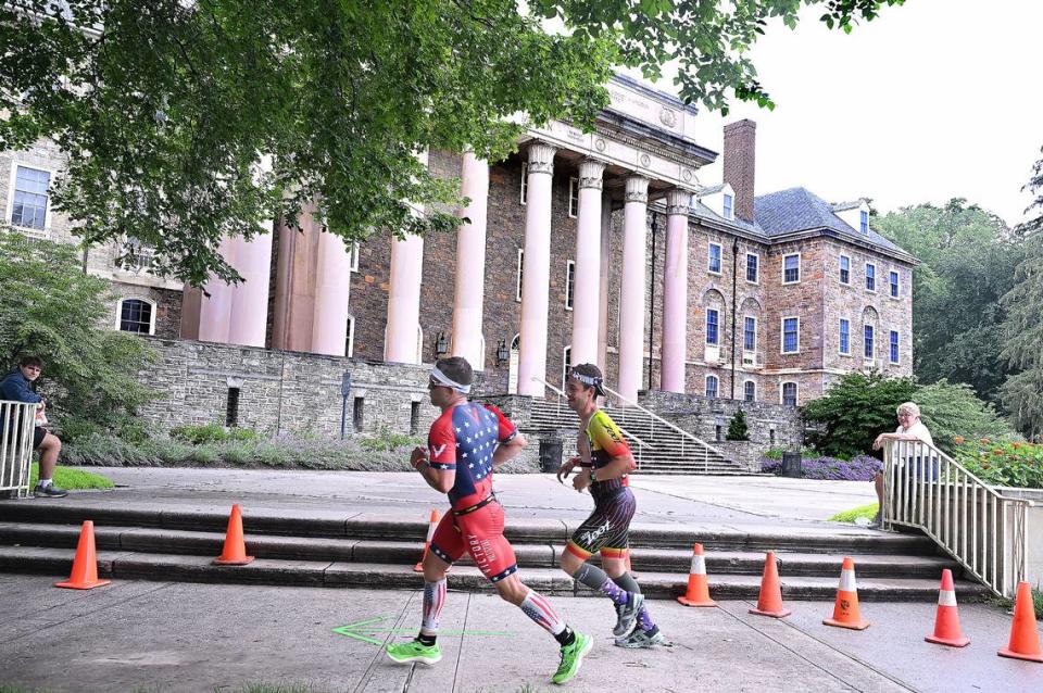 Participants in the Ironman 70.3 Pennsylvania Happy Valley run past Old Main on the Penn State campus Sunday, July 2, 2023. Steve Manuel/For the CDT