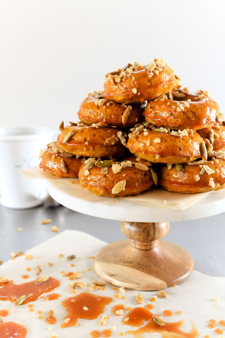 <p>Easy baked donuts dipped into an irresistible caramel glaze and topped with crunchy candied pepitas is the fall dessert (or breakfast!) everyone will be talking about 'til summer.</p><p><em><a href="https://www.thepioneerwoman.com/food-cooking/recipes/a80231/pumpkin-spiced-donuts-with-bourbon-caramel-glaze/" rel="nofollow noopener" target="_blank" data-ylk="slk:Get the recipe from The Pioneer Woman »;elm:context_link;itc:0;sec:content-canvas" class="link ">Get the recipe from The Pioneer Woman »</a></em></p>