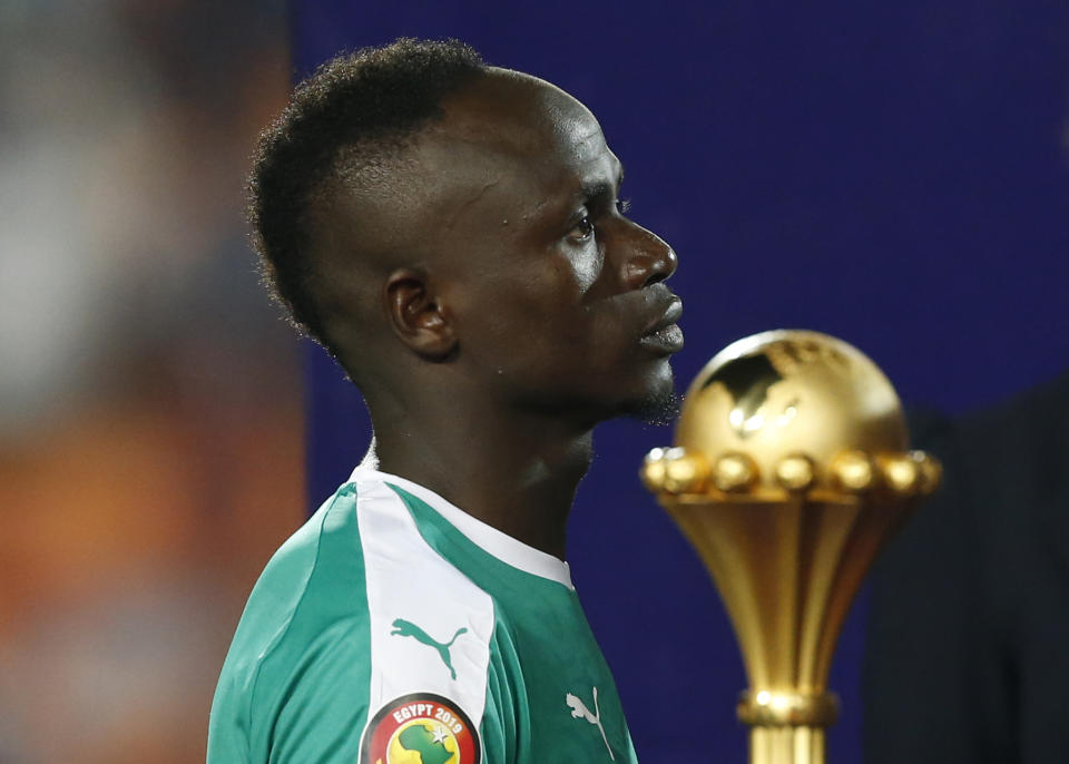 Senegal's Sadio Mane walks past the Cup after the African Cup of Nations final soccer match between Algeria and Senegal in Cairo International stadium in Cairo, Egypt, Friday, July 19, 2019. Algeria won 1-0. (AP Photo/Ariel Schalit)