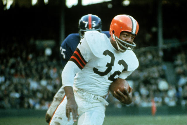 FILE - Jimmy Brown (32), running back for the Cleveland Browns, is shown in action against the New York Giants in Cleveland, Ohio, on Nov. 14, 1965. NFL legend, actor and social activist Jim Brown passed away peacefully in his Los Angeles home on Thursday night, May 18, 2023, with his wife, Monique, by his side, according to a spokeswoman for Brown's family. He was 87. (AP Photo/File)
