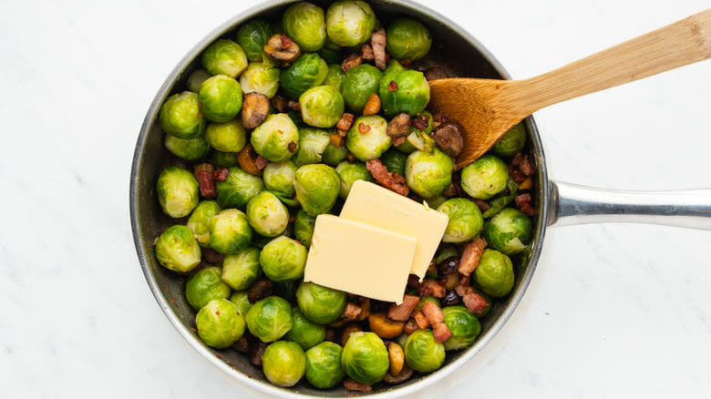 Bacon, chestnut, sprouts, and butter in pan