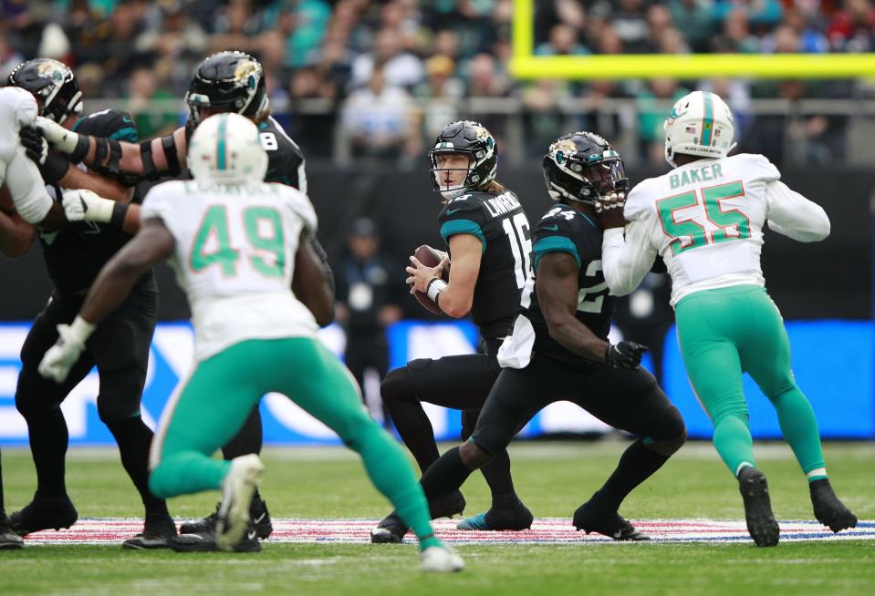 Jacksonville Jaguars quarterback Trevor Lawrence (16) prepares to pass the ball against the Miami Dolphins at the Tottenham Hotspur stadium in London, England, Sunday, Oct. 17, 2021.