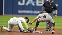 Tampa Bay Rays' Harold Ramírez, left, gets back safely ahead of the tag by San Francisco Giants second baseman Thairo Estrada after Ramirez over ran the base on an infield single by Amed Rosario during the second inning of a baseball game Friday, April 12, 2024, in St. Petersburg, Fla. (AP Photo/Chris O'Meara)