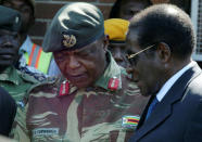 FILE PHOTO: President Robert Mugabe talks to General Constantino Chiwenga in Harare, Zimbabwe, July 4, 2008. REUTERS/Philimon Bulawayo/File Photo