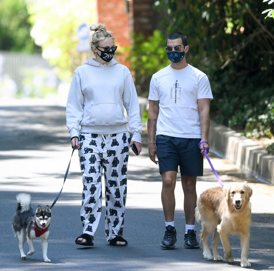 <p>Joe Jonas and Sophie Turner mask up for a walk with their dogs in Los Angeles on Monday.</p>
