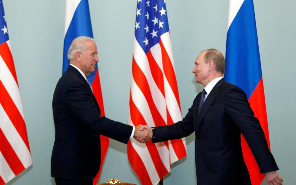 Joe Biden shakes hands with Vladimir Putin in Moscow in 2011 - Alexander Zemlianichenko/AP