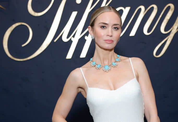 Celebrity in a white sleeveless gown with a decorative turquoise necklace at a Tiffany event