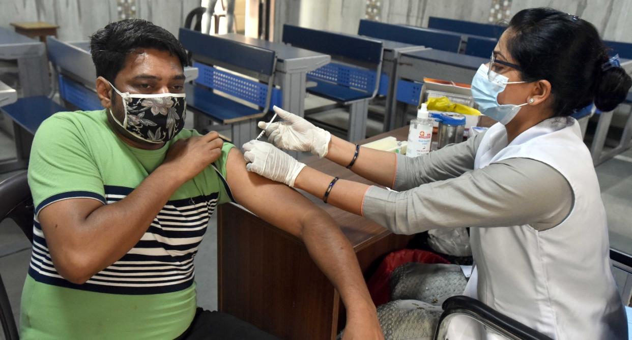 A health worker administers a dose of Covid vaccine to a beneficiary, during a vaccination drive for the age group of 18 to 44, at a government school, on May 17, 2021 in New Delhi. Photo: Sonu Mehta/Hindustan Times via Getty Images
