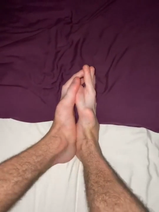 Hands forming a quirky optical illusion of a fake leg against a two-toned background