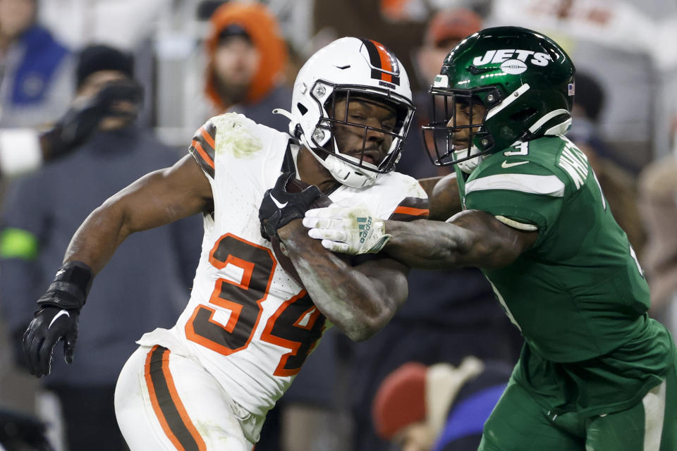 Cleveland Browns running back Jerome Ford scores past New York Jets safety Jordan Whitehead during the first half of an NFL football game Thursday, Dec. 28, 2023, in Cleveland. (AP Photo/Ron Schwane)