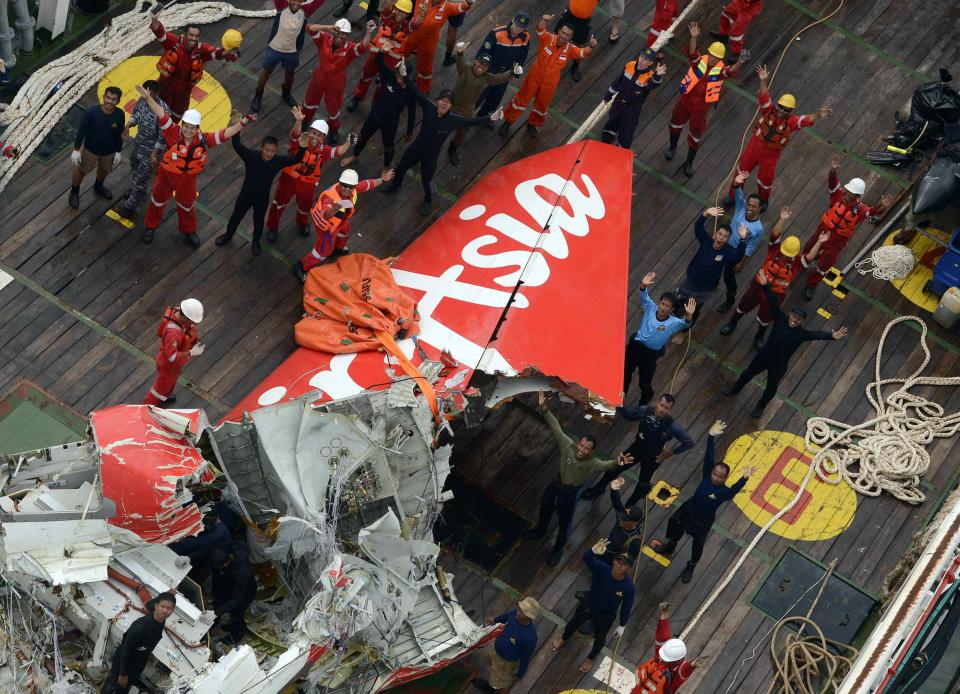 The tail of AirAsia QZ8501 passenger plane is seen on the deck of the Indonesian Search and Rescue (BASARNAS) ship Crest Onyx after it was lifted from the sea bed, south of Pangkalan Bun, Central Kalimantan January 10, 2015. Indonesian search and rescue teams raised on Saturday the tail of an AirAsia passenger jet that crashed nearly two weeks ago with the loss of all 162 people on board, and will soon search it for the flight recorders. Indonesia AirAsia Flight QZ8501 lost contact with air traffic control during bad weather on Dec. 28, less than half way into a two-hour flight from Indonesia to Singapore. There were no survivors. REUTERS/Prasetyo Utomo/Pool (INDONESIA - Tags: DISASTER TRANSPORT MILITARY TPX IMAGES OF THE DAY)