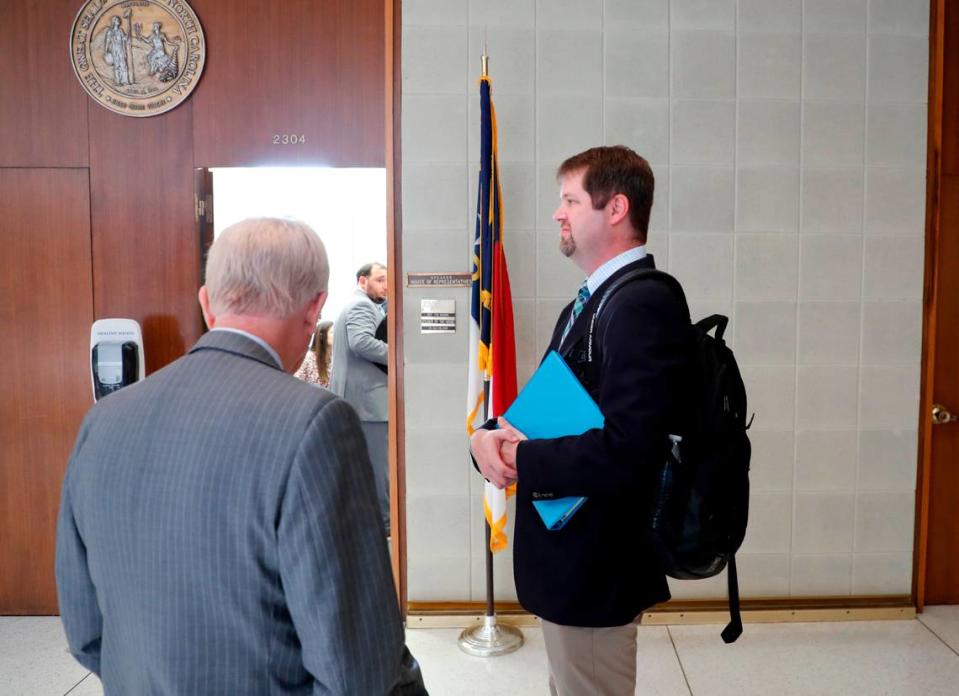 James Alverson, assistant commissioner with the N.C. High School Athletic Association, right, and lobbyist Randolph Cloud wait outside the office on N.C. House Speaker Tim Moore in Raleigh, N.C. Wednesday, July 21, 2021.