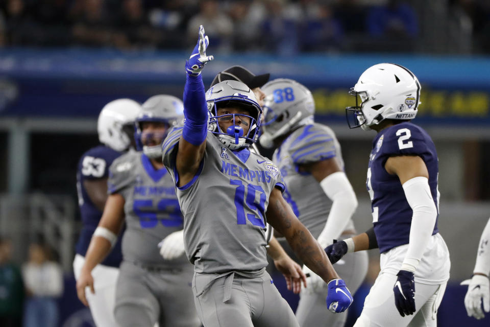 FILE - Memphis running back Kenneth Gainwell (19) reacts after a first down run during the second half of the NCAA Cotton Bowl college football game against Penn State in Arlington, Texas, in this Saturday, Dec. 28, 2019, file photo. Gainwell had every intention of playing football with the Memphis Tigers last fall, going through fall practice. The funeral for an uncle, the fourth member of his family to die of COVID-19 made opting out of the season the best decision for Gainwell. (AP Photo/Roger Steinman, File)