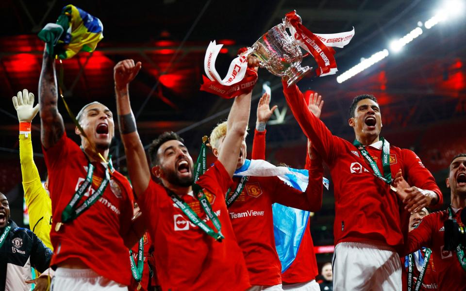 Manchester United's Raphael Varane celebrates with the trophy and with Bruno Fernandes, Alejandro Garnacho and Antony - Action Images via Reuters