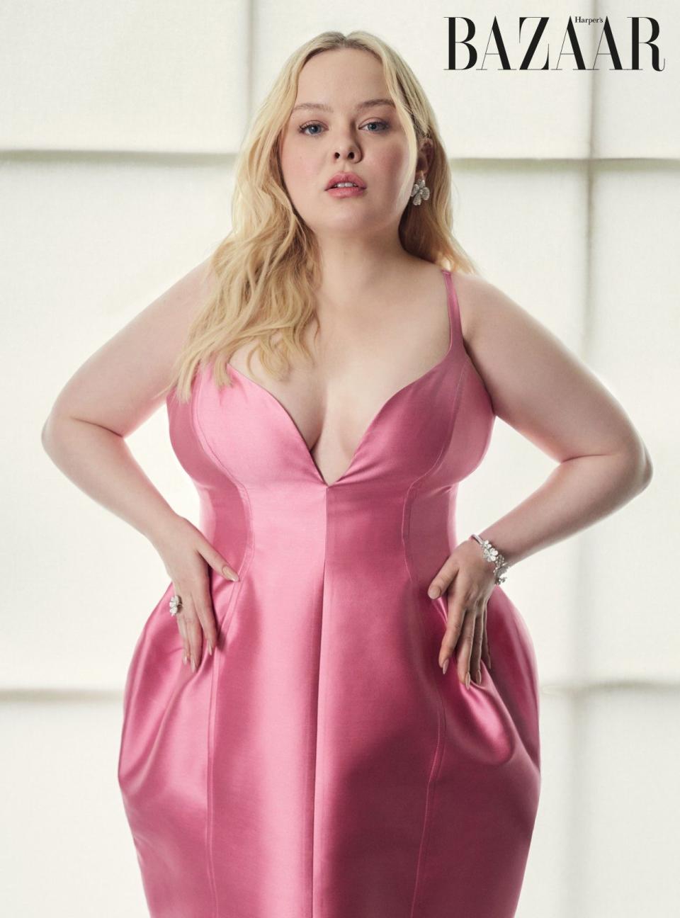 Nicola Coughlan posing in a pink dress