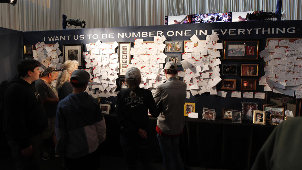 Fans look at a wall of notes at a five-hour memorial for Denver Broncos owner Pat Bowlen Tuesday, June 18, 2019, at Mile High Stadium, the NFL football team's home in Denver. Bowlen, who has owned the franchise for more than three decades, died last Thursday. (AP Photo/David Zalubowski)