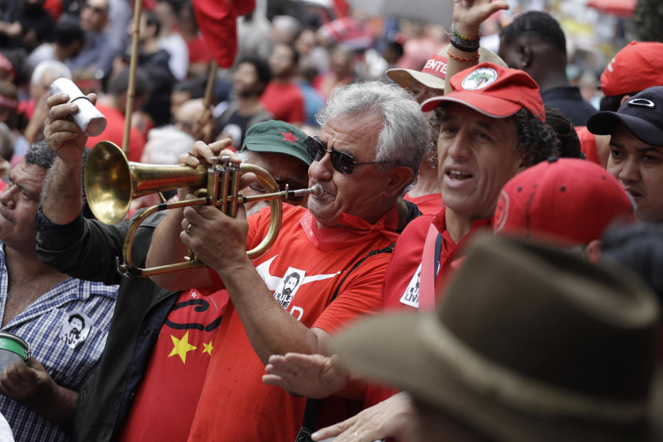 Supporters of Brazil's former President Luiz Inacio Lula da Silva wait for him to speak at a rally at the Metal Workers Union headquarters, in Sao Bernardo, Brazil, Saturday, Nov. 9, 2019. Da Silva was released from jail Friday, less than a day after the Supreme Court ruled that a person can be imprisoned only after all the appeals have been exhausted. (AP Photo/Nelson Antoine)