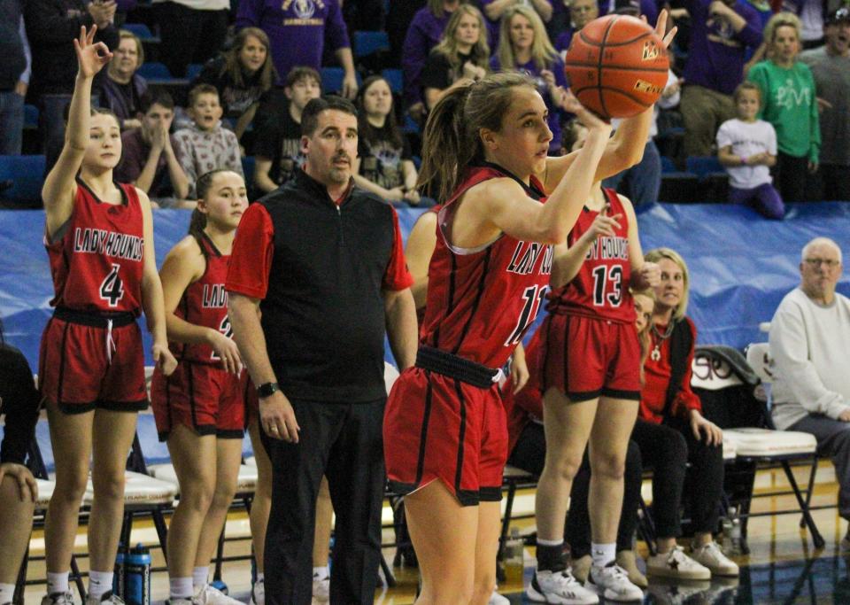 Gruver's Brenna Butler attempts a 3-pointer in front of her bench during the Region I-2A championship girls basketball playoff game in the Texan Dome in Levelland on Saturday, Feb. 25, 2023.
