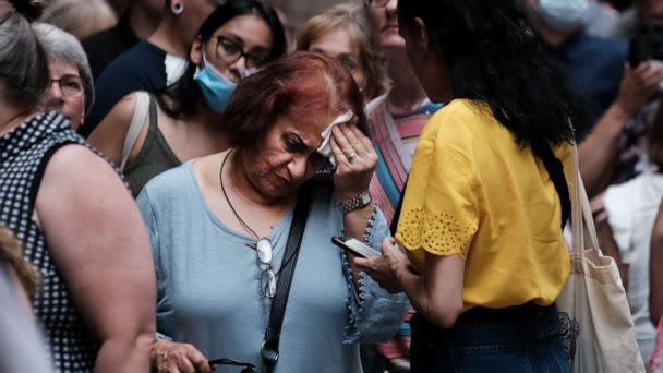 PHOTO: A woman wipes her brow as people wait in line to see Phantom of the Opera in midtown Manhattan as temperatures reach into the 90s on July 21, 2022, in New York City. (Spencer Platt/Getty Images, FILE)