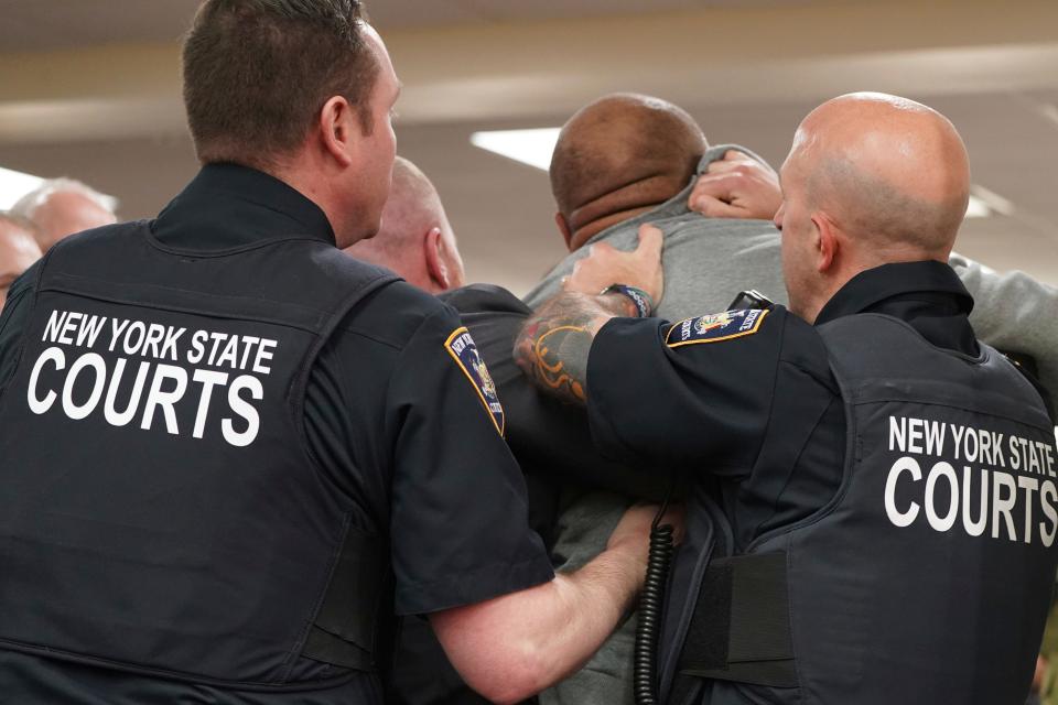 Court officers restrain and remove a man that lunged towards Tops gunman Payton Gendron during his sentencing at Erie County Court in Buffalo, N.Y.,  Wednesday, Feb 15, 2023.