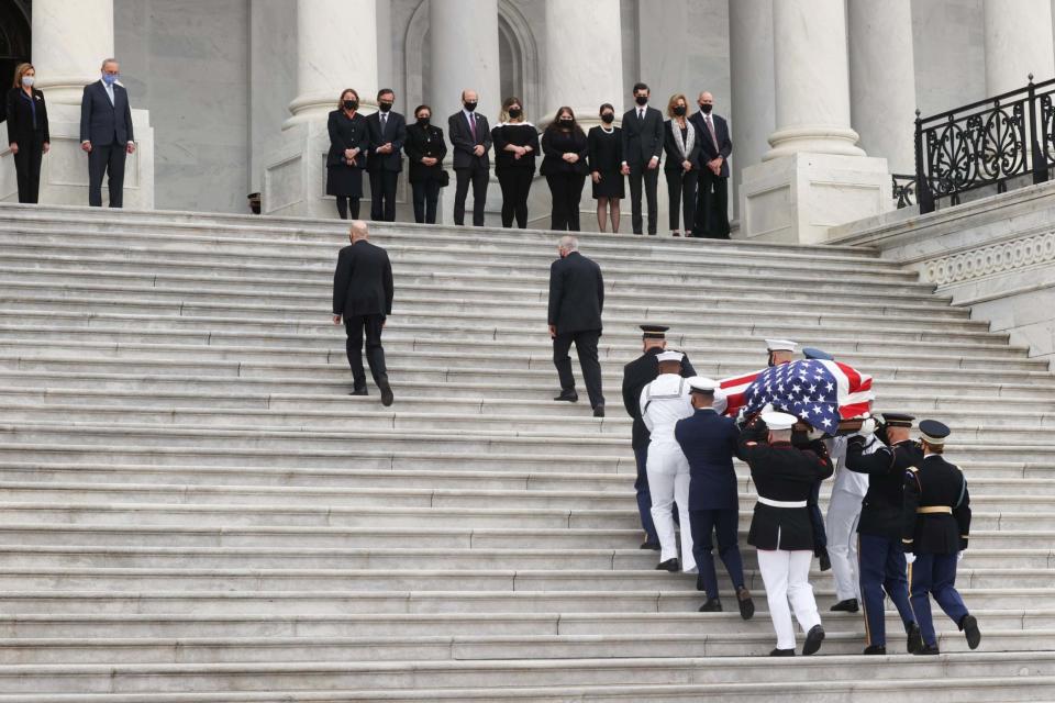 The casket of the late Supreme Court Associate Justice Ruth Bader Ginsburg is carried by a military guard up the steps of the US Capitol (REUTERS)