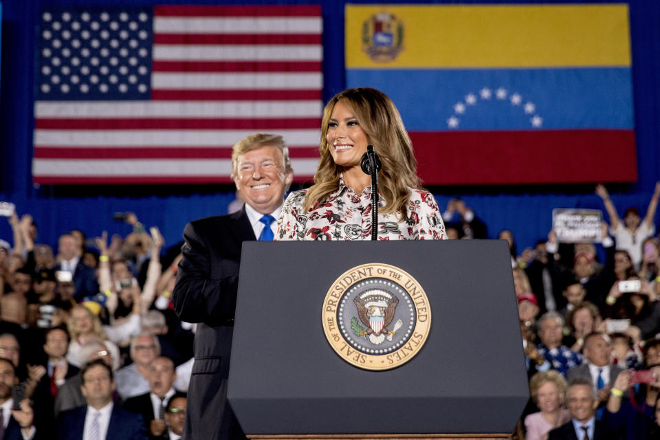 First lady Melania Trump, accompanied by President Donald Trump, smiles as she speaks in front of a Venezuelan American community at Florida Ocean Bank Convocation Center at Florida International University in Miami, Fla., Monday, Feb. 18, 2019, as Trump speaks out against President Nicolas Maduro's government and its socialist policies. (AP Photo/Andrew Harnik)