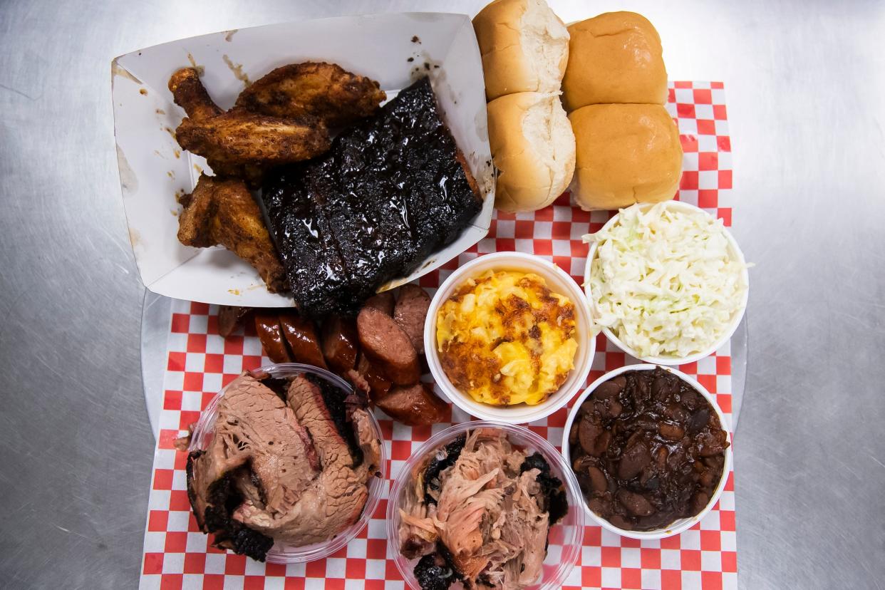 The BBQ sampler at Road Hawg Barbecue includes traditional favorites like ribs, wings, pulled pork, brisket, sides and rolls.