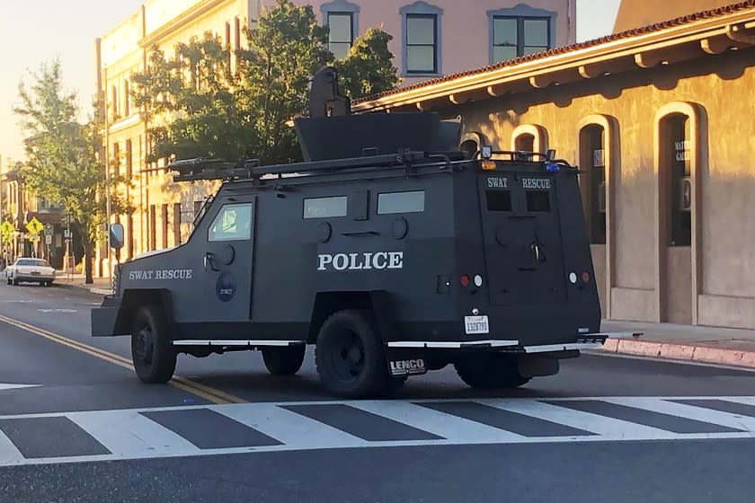 In this image taken from video and provided by KSBY-TV, an armored vehicle patrols the streets of Paso Robles in California's Central Coast region after a sheriff's deputy was wounded after someone opened fire on a police station early Wednesday, June 10, 2020. The motive was not known. San Luis Obispo County authorities say the shooting began around 3:45 a.m. in Paso Robles and the deputy responded. He was reported to be in serious but stable condition. Gunfire occurred over a span of some minutes but details are unclear. (KSBY-TV via AP)