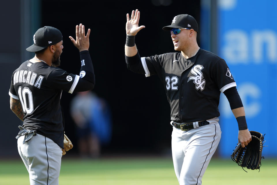 Chicago White Sox right fielder Gavin Sheets (32) and Yoan Moncada (10) celebrate a win over the Cleveland Guardians in a baseball game, Thursday, Sept. 15, 2022, in Cleveland. (AP Photo/Ron Schwane)
