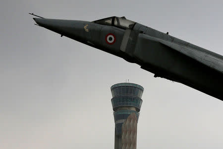 An air traffic control tower and a model of a fighter plane are pictured at the Indira Gandhi International Airport in New Delhi, India, August 23, 2017. REUTERS/Adnan Abidi