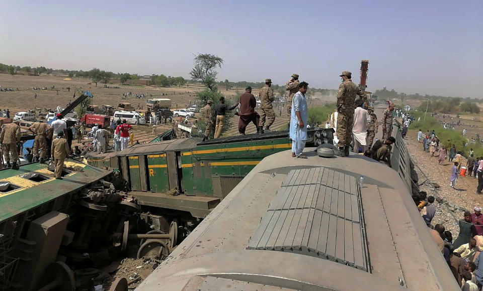 In this photo released by Pakistan's army media wing Inter Services Public Relations, troops and rescuers work at the site of a train collision in Ghotki district in the southern Pakistan, Monday, June 7, 2021. Two express trains collided in southern Pakistan early Monday, killing dozens of passengers, authorities said, as rescuers and villagers worked to pull injured people and more bodies from the wreckage. (Inter Services Public Relations vis AP)