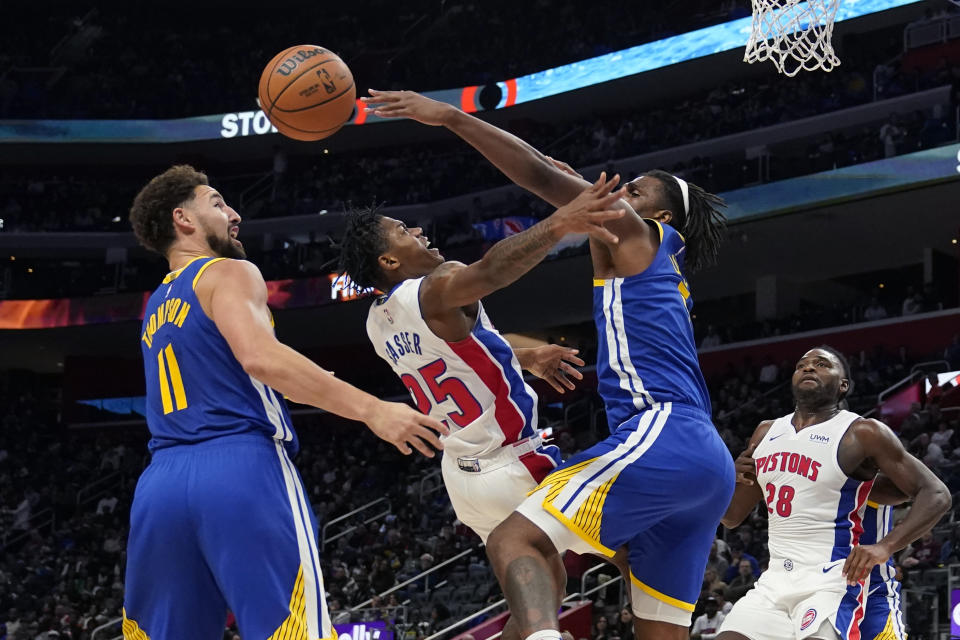 Golden State Warriors forward Kevon Looney blocks a shot by Detroit Pistons guard Marcus Sasser (25) during the first half of an NBA basketball game, Monday, Nov. 6, 2023, in Detroit. (AP Photo/Carlos Osorio)