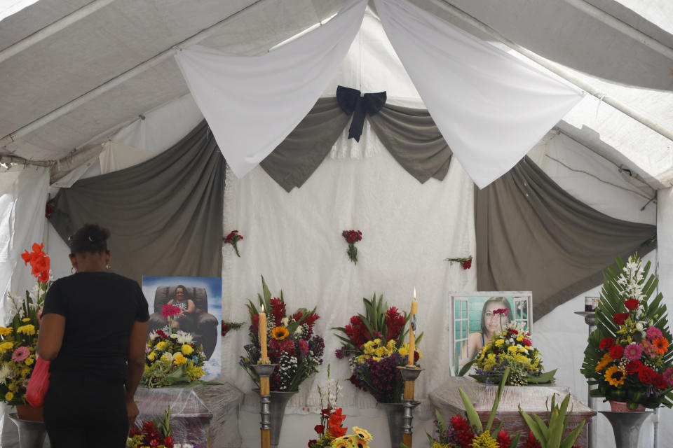 The coffins of Maribel Euseda, left, and her daughter Karla Euseda are displayed during their wake in Tegucigalpa, Honduras, Thursday, June 22, 2023. The mother and daughter died in a riot on June 20 at a women's prison northwest of the Honduran capital that killed at least 46 inmates, many of them burned, shot or stabbed to death, according to police. (AP Photo/Elmer Martinez)