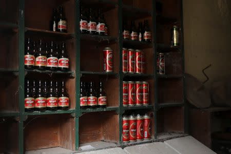 Empty beer cans and bottles sit on shelves inside an abandoned shop in the village of Papratna, near the south-eastern town of Knjazevac, Serbia, August 14, 2016. REUTERS/Marko Djurica