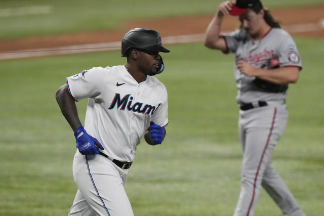 Miami Marlins' Jean Segura (9) hits a single to score the winning run  during the ninth inning of a baseball game against the Chicago Cubs,  Friday, April 28, 2023, in Miami. The