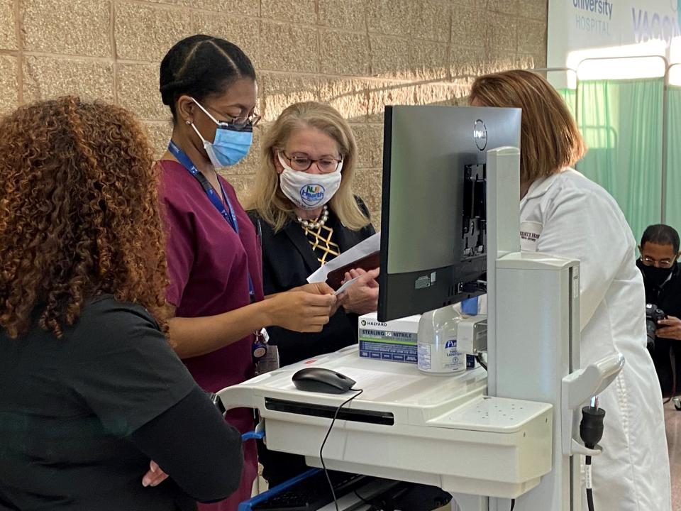 New Jersey Health Commissioner Judy Persichilli, center, talks with heath care workers at University Hospital in Newark as they prepare to give their co-workers the first doses of the COVID vaccine on Tuesday, Dec. 15, 2020