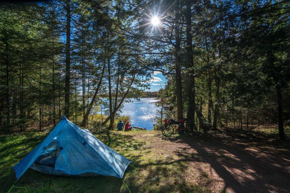 A couple of Tour de Chequamegon riders enjoy the sunset at Moose Lake Campground east of Hayward after a day riding.