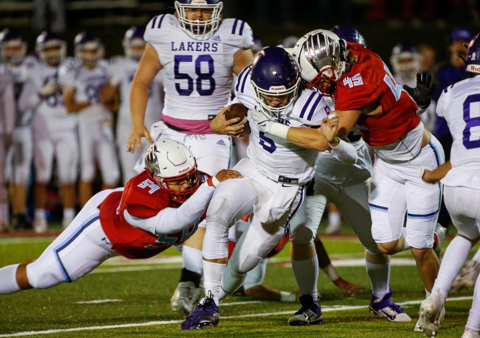 Kellen Lindstrom (45) and Jaxon Lockett (54), of Glendale, bring down Bear Shore during the Falcons game against Camdenton at Glendale High School on Friday, Oct. 15, 2021.