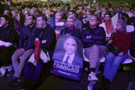 A supporter of French far right presidential candidate Eric Zemmour holds a campaign poster of Zemmour during his first rally, Sunday, Dec. 5, 2021 in Villepinte, north of Paris. Far-right former French TV pundit Eric Zemmour is holding his first campaign rally, a few days after he formally declared his candidacy for April's presidential election in a video relaying his anti-migrants, anti Islam views. A first round is to be held on April, 10, 2022 and should no candidate win a majority of the vote in the first round, a runoff will be held between the top two candidates on April 24, 2022. (AP Photo/Rafael Yaghobzadeh)