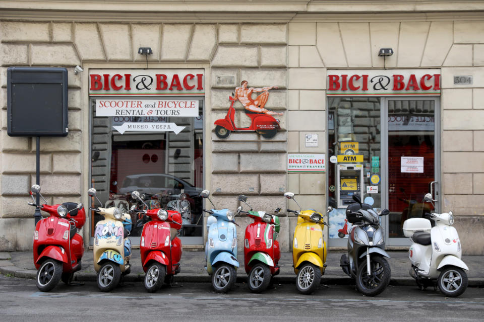 Vespa scooters stand outside a closed rental shop in Rome, Italy, on Friday, March 27, 2020. European Union leaders failed to agree on key details of economic rescue measures, as Italy's coronavirus infections surged despite weeks of restrictions on public life, worsening Europes human cost. Photographer: Alessia Pierdomenico/Bloomberg via Getty Images