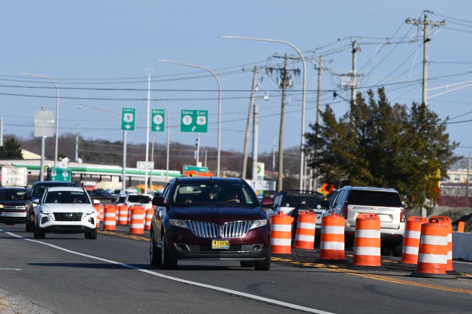 Cars navigate through traffic barrels on Route 9 in Lewes Dec. 8, 2023.