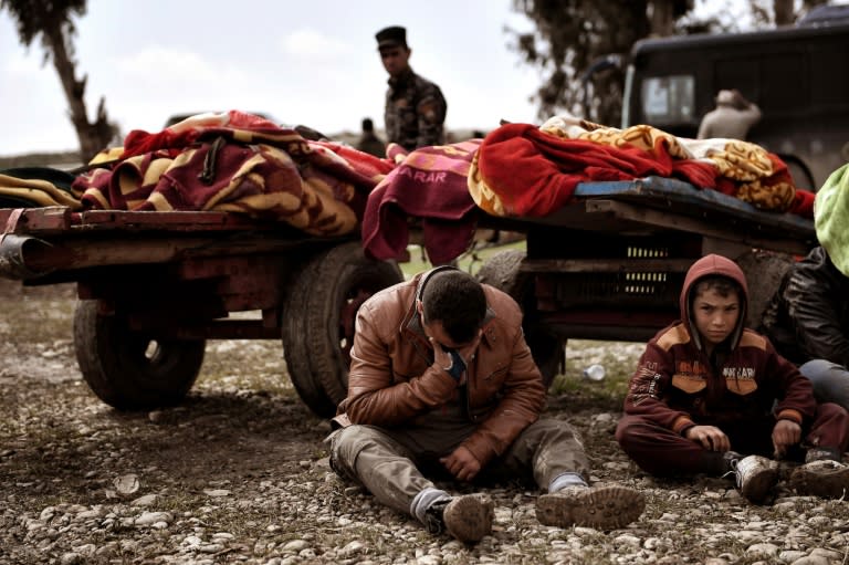 Relatives mourn as bodies of Iraqis allegedly killed in a west Mosul airstrike targeting IS jihadists are covered with blankets